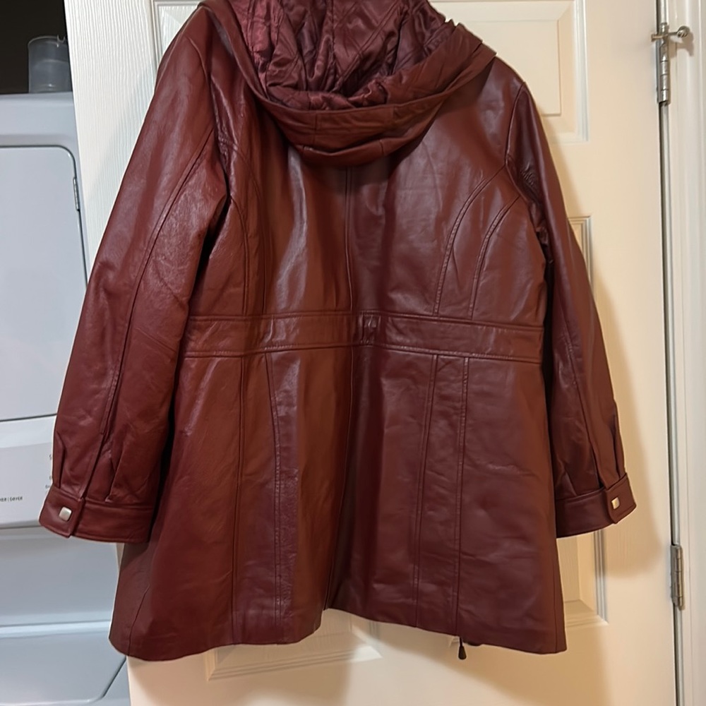 Burgundy 3/4 quarter leather coat. Measures 45” around waist area.